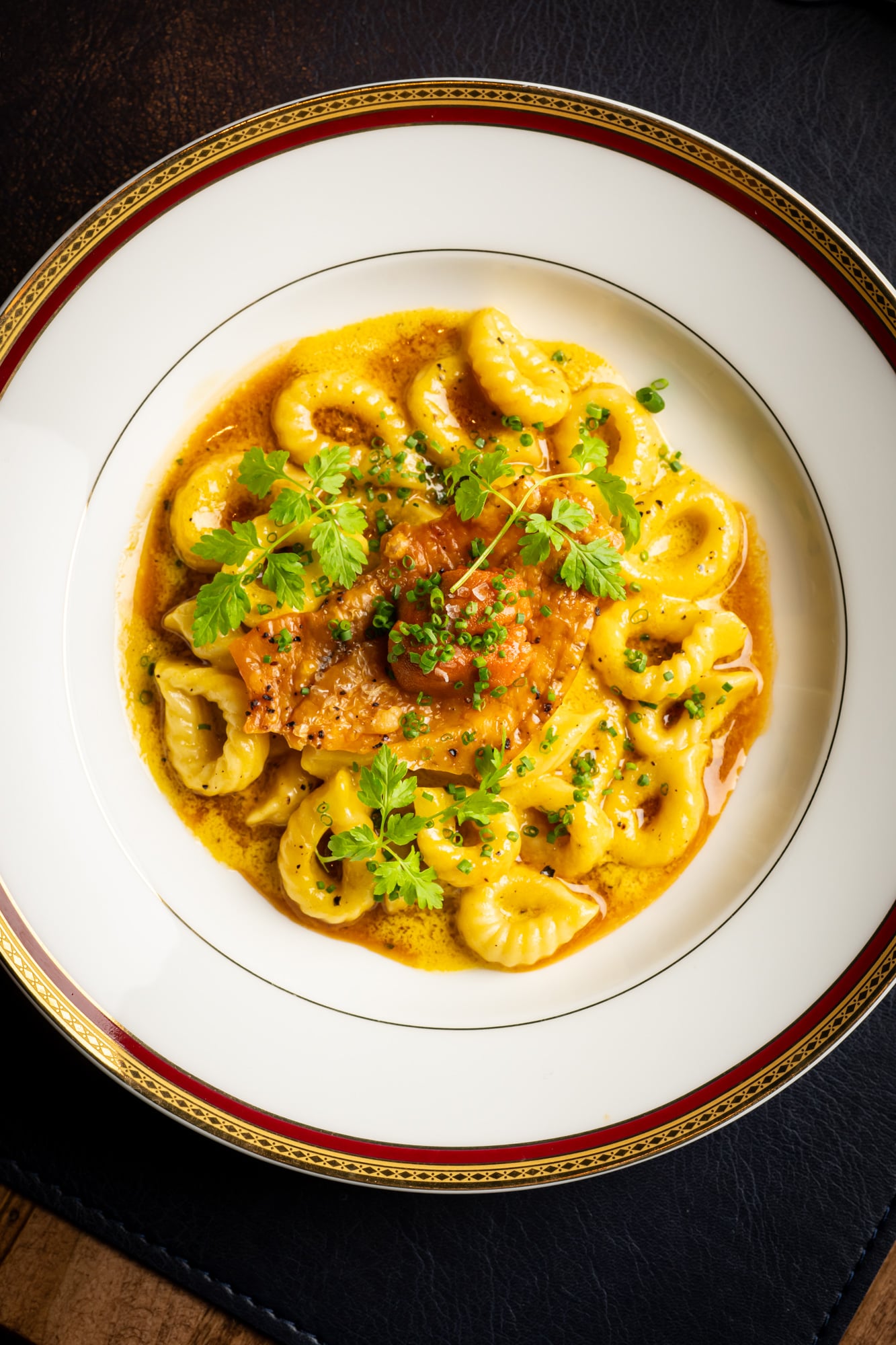 Tortellini in golden broth with fresh herbs