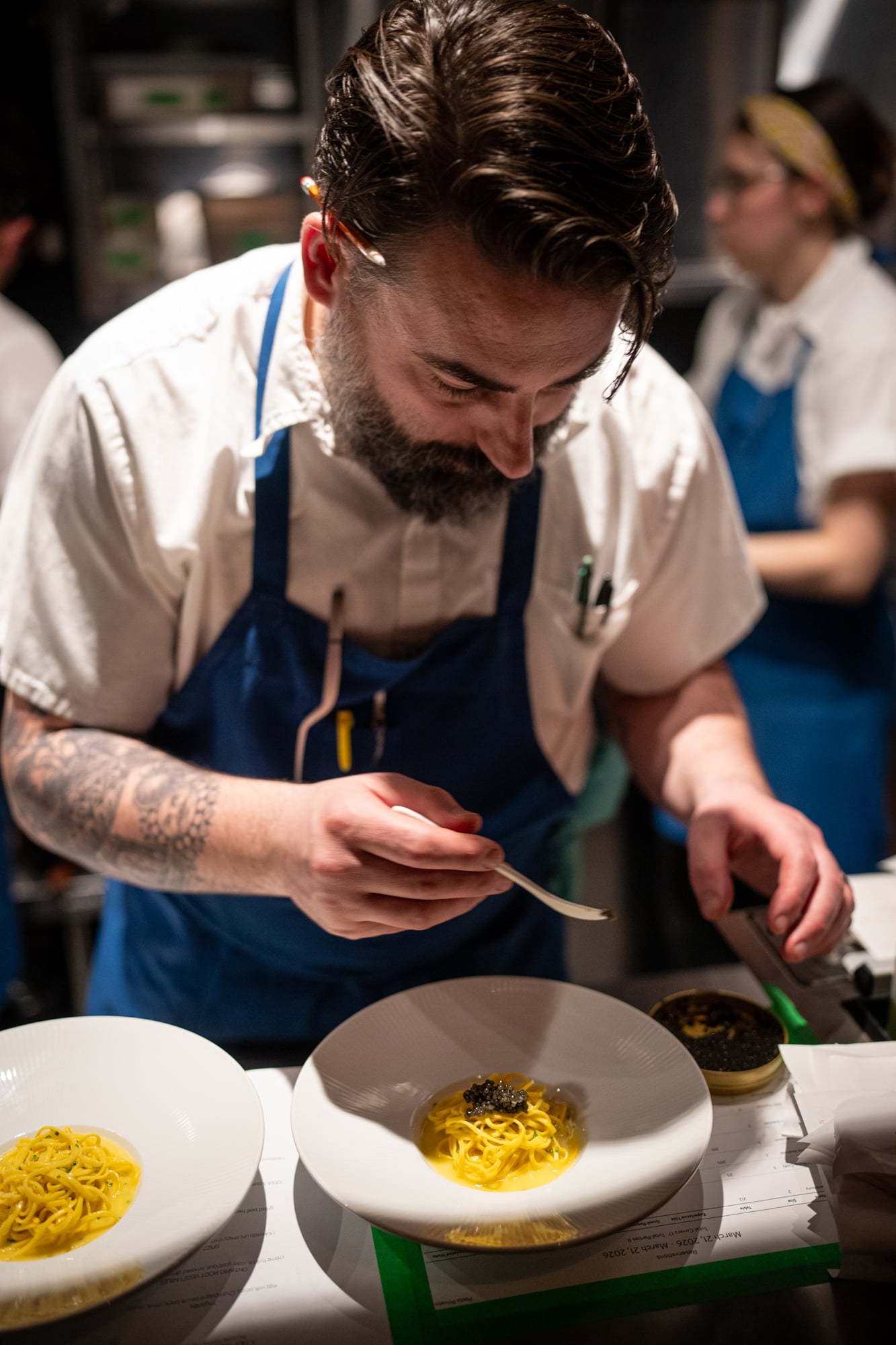 Chef plating tagliolini with caviar