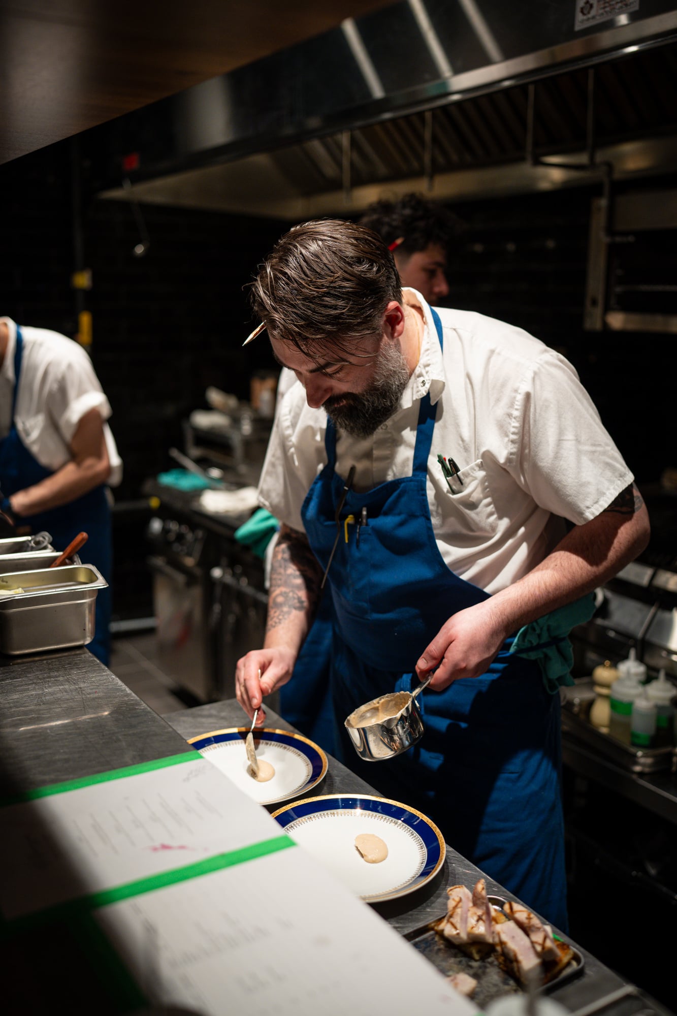 Chef plating a dish at the pass