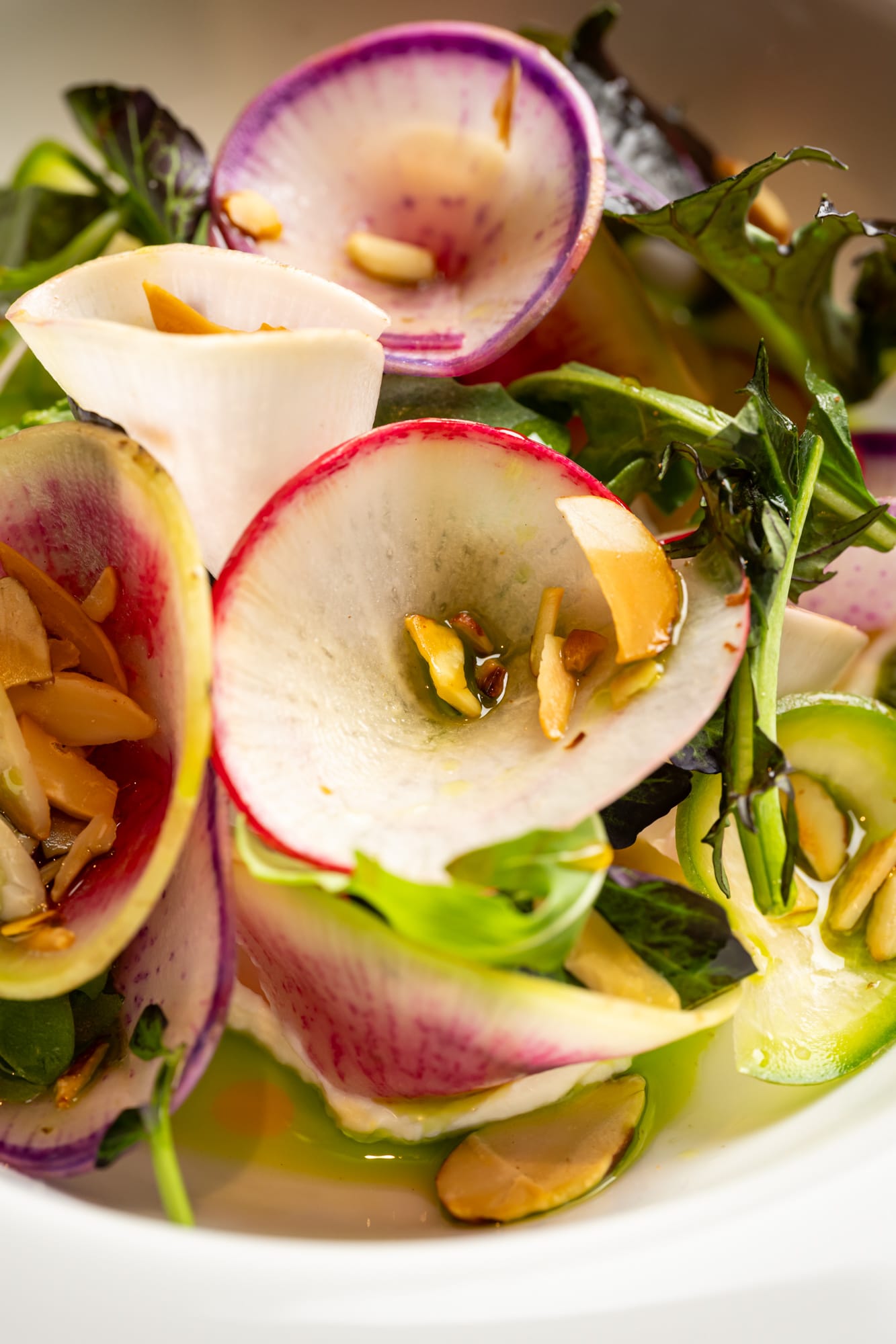 Close-up of tortellini in sauce with fresh herbs